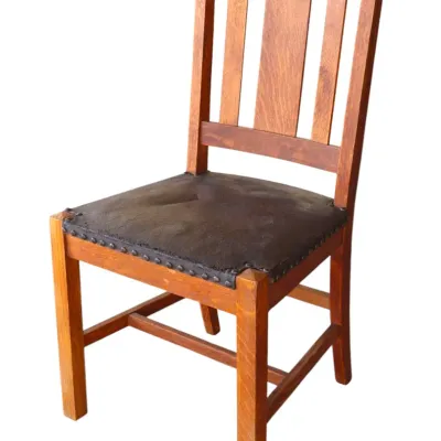 Sale Photo Thumbnail #237: Arts and Crafts style oak dining chair with a slat back and dark upholstered seat trim with nailhead accents.