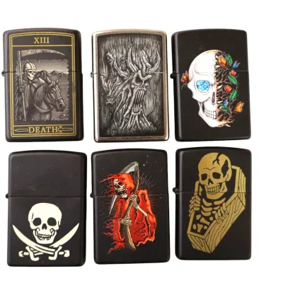 Sale Photo Thumbnail #190: Collection of six Zippo-style flip lighters featuring macabre and gothic artwork, including skulls, Grim Reapers, and a tarot Death card.