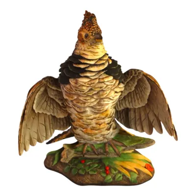Sale Photo Thumbnail #62: BOEHM hand-painted porcelain grouse figurine with outstretched wings perched on a foliage base.