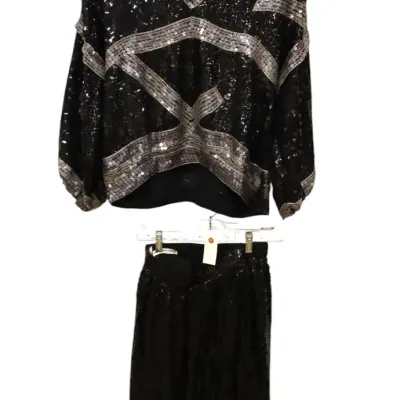 Sale Photo Thumbnail #215: Vintage 1980s two-piece black and silver sequined set, featuring a v-neck long-sleeve top with geometric patterning and a matching black skirt.