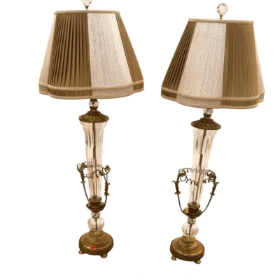 Sale Photo Thumbnail #139: Pair of Hollywood Regency style brass and cut crystal table lamps featuring scroll accents, crystal finials, and pleated fabric shades.
