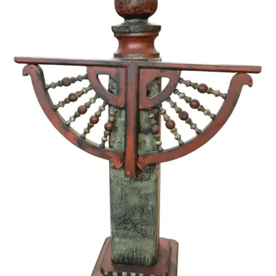 Sale Photo Thumbnail #275: Hand-painted assemblage wooden sculpture by Kathy Gaulke, featuring distressed red and green finish with decorative turned spindles and a sphere finial.