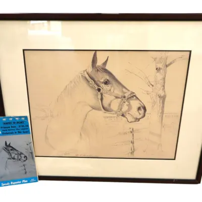 Sale Photo Thumbnail #130: Framed pencil sketch of a horse profile in a dark wood frame, displayed alongside a copy of American Turf Monthly magazine featuring the artwork on its cover.