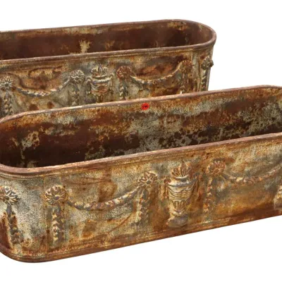 Sale Photo Thumbnail #55: Pair of antique-style cast iron oval trough planters featuring classical urn and floral swag relief details with a heavily weathered, rusted finish.