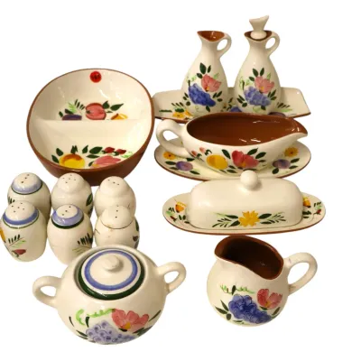 Sale Photo Thumbnail #289: Vintage hand-painted ceramic serveware collection featuring floral and fruit motifs, including salt and pepper shakers, a gravy boat, oil and vinegar cruets, a covered butter dish, and a cream and sugar set.