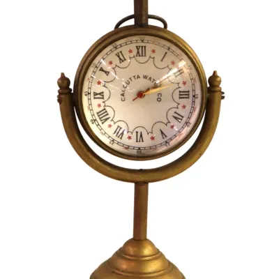 Sale Photo Thumbnail #107: Vintage brass pedestal desk clock featuring a swivel dial marked Calcutta Watch Co. with Roman numerals.