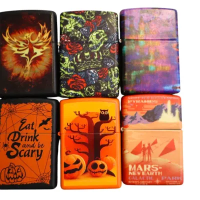 Sale Photo Thumbnail #165: Collection of six Zippo-style lighters featuring various graphic designs, including Halloween, fantasy, sci-fi, and abstract motifs.