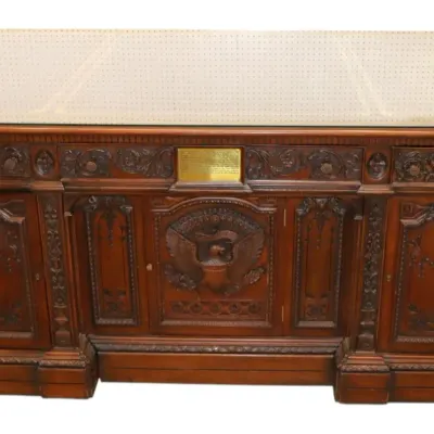 Sale Photo Thumbnail #19: Intricately carved dark wood Resolute desk replica with a protective glass top and brass presentation plaque.