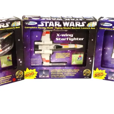Sale Photo Thumbnail #111: Set of three Estes Star Wars complete ready-built flying model rocket launch sets, including X-Wing Starfighters and R2-D2 models, all in original packaging.