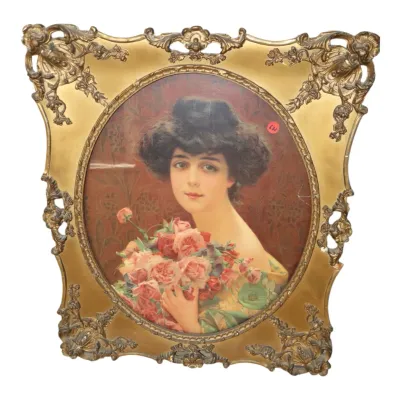 Sale Photo Thumbnail #128: Antique Edwardian-style oval portrait of a young woman holding a bouquet of roses, framed in an ornate gilded Rococo-style metallic frame.