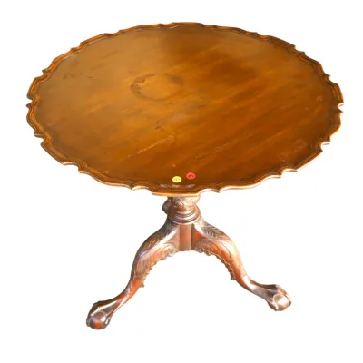 Sale Photo Thumbnail #302: Vintage Chippendale-style mahogany tilt-top tea table featuring a piecrust rim, carved pedestal, and tripod legs with ball-and-claw feet.