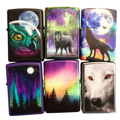 Sale Photo Thumbnail #164: Collection of six Zippo-style lighters featuring wildlife and nature graphic designs, including wolves, owls, and northern lights.