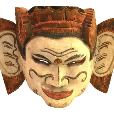 Sale Photo Thumbnail #53: Hand-carved and painted wooden Indonesian Topeng theatrical mask, featuring large stylized ears, an ornate headpiece, and painted face detailing with natural age patina.