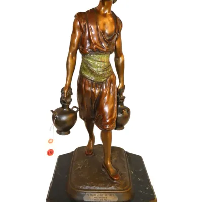 Sale Photo Thumbnail #97: 19thC French Orientalist bronze sculpture titled "Porteur d'Eau Tunisien" by Jean Didier Debut, featuring a water carrier on a black marble base.