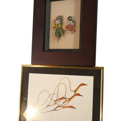 Sale Photo Thumbnail #138: Pair of framed artworks including a shadowbox display of two miniature beaded Native American style figures and a framed print titled "Spring Flight" by Benjamin Chee Chee.