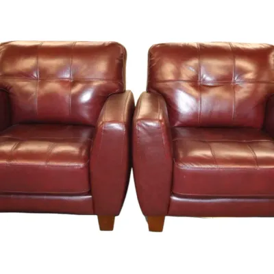 Sale Photo Thumbnail #266: Pair of modern burgundy leather armchairs featuring grid-tufted backs and seats with tapered wooden feet.
