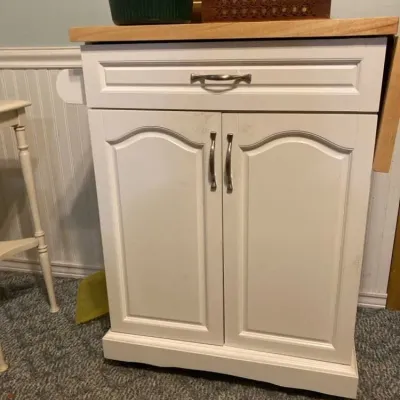 Sale Photo Thumbnail #2: White wooden kitchen island cart featuring a butcher block top, single upper drawer, double-door cabinet below.