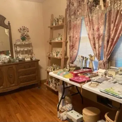 Sale Photo Thumbnail #4: Bedroom set featuring a wooden triple dresser with a framed mirror, angel figurine collections.