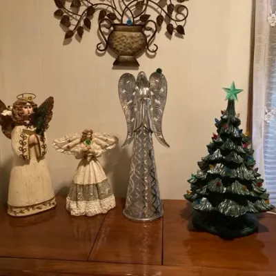 Sale Photo Thumbnail #9: Collection of holiday decorations including three angel figurines in various styles and a vintage lighted green ceramic Christmas tree.