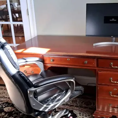 Harden Seven-Drawer Wood Executive Desk, Black Office Chair and LG Monitor