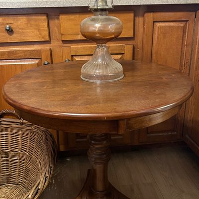 Sale Photo Thumbnail #47: Vintage clear glass oil lamp with etched shade, displayed atop a round wooden pedestal accent table.