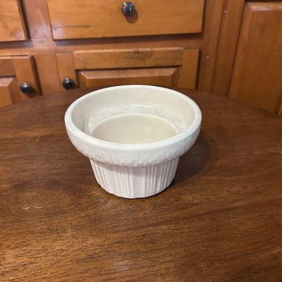Sale Photo Thumbnail #19: Vintage off-white ceramic pottery bowl featuring a ribbed lower base and wide flared rim.