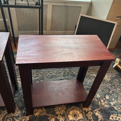 Sale Photo Thumbnail #87: Modern dark reddish-brown wooden end table featuring a clean-lined rectangular top and a lower storage shelf.