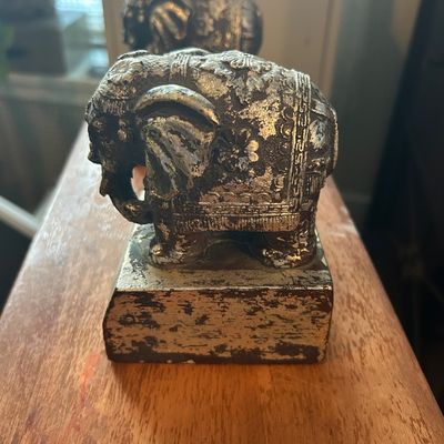 Sale Photo Thumbnail #52: Pair of vintage ornate elephant bookends featuring silver-tone painted cast metal construction with a distressed finish.
