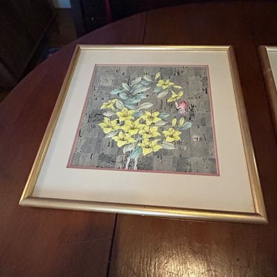 Sale Photo Thumbnail #77: Framed Asian-style floral print featuring yellow flowers and a butterfly on a patterned background, housed in a thin gold-toned wood frame.