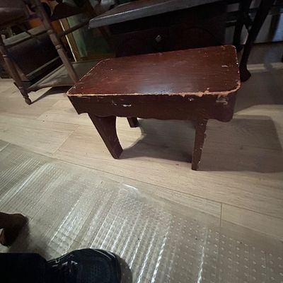 Sale Photo Thumbnail #119: Vintage dark-stained wooden step stool showing edge wear and surface distress from age and use.