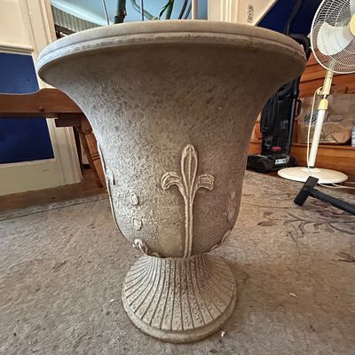 Sale Photo Thumbnail #98: Large stone-look cast urn planter with raised fleur-de-lis motifs and a fluted pediment base.