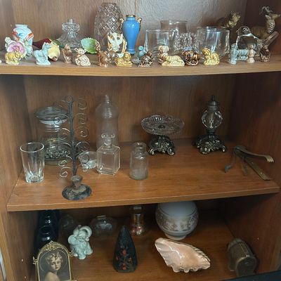 Sale Photo Thumbnail #61: Wooden display bookcase filled with vintage collectibles, including miniature animal figurines, glass apothecary jars, cut crystal pieces, and decorative trinkets.