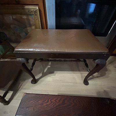 Sale Photo Thumbnail #120: Vintage padded bench with brown vinyl upholstery and cabriole legs, showing light surface wear.