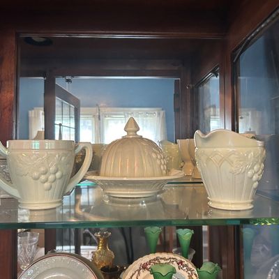 Sale Photo Thumbnail #60: Three-piece vintage milk glass set with embossed grape motifs, including a covered butter dish, sugar bowl, and creamer.