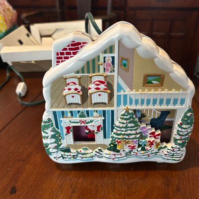 Sale Photo Thumbnail #32: Vintage Mr. Christmas illuminated holiday dollhouse decoration, featuring two stories of detailed festive interior scenes with lights and a power cord attached.