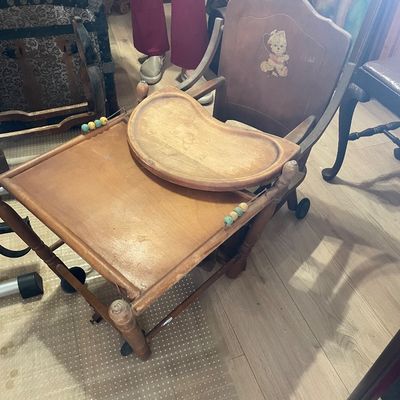 Sale Photo Thumbnail #9: Vintage convertible wooden high chair that lowers into a play table, featuring a teddy bear decal on the backrest and colorful side beads.
