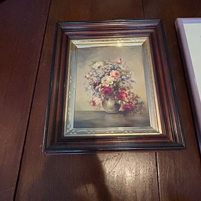 Sale Photo Thumbnail #66: Framed floral still life print depicting roses and mixed flowers in a vase, housed in a dark wooden frame with a silver gilt inner border.