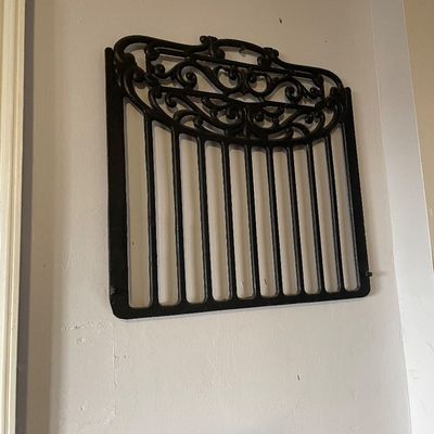 Sale Photo Thumbnail #10: Black painted cast iron wall grate or gate panel featuring vertical bars and ornate scrollwork along the top.