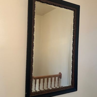 Sale Photo Thumbnail #49: Large rectangular wall mirror featuring a painted black outer frame with a detailed, dark wood carved inner trim.