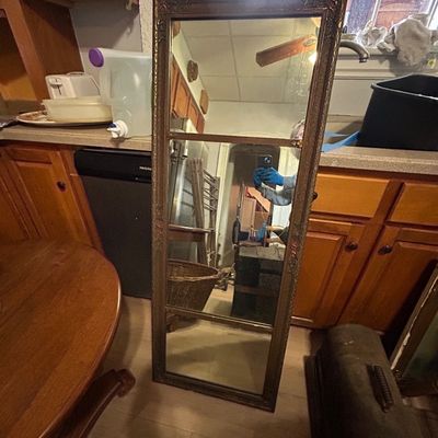 Sale Photo Thumbnail #46: Tall vintage wall mirror with a ornate brass frame and three divided glass panels.