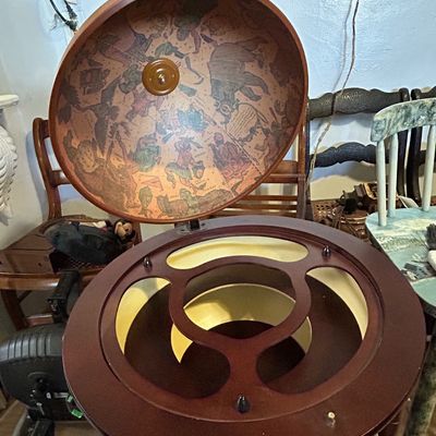 Sale Photo Thumbnail #109: Vintage Italian-style world globe bar cart, featuring a hinged lid opening to reveal interior storage with astrological illustrations.