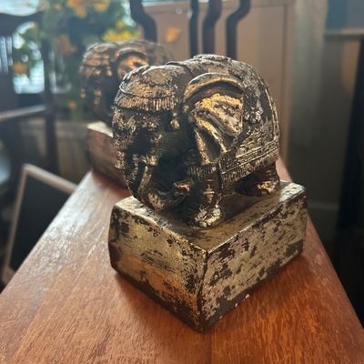 Sale Photo Thumbnail #53: Pair of ornate elephant bookends featuring a distressed silver and gold leaf finish on block bases.