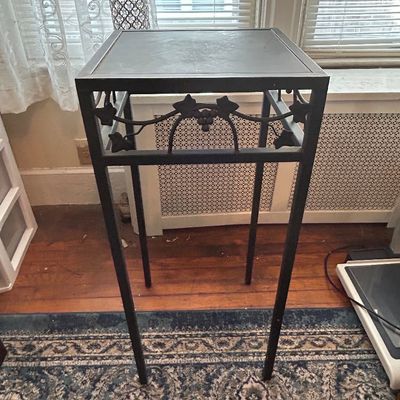 Sale Photo Thumbnail #89: Black wrought iron tall plant stand or side table featuring a grapevine motif apron and inset glass top.