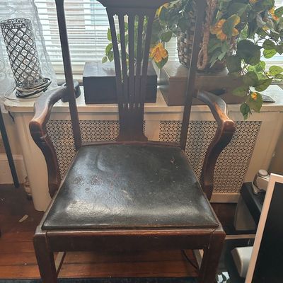 Sale Photo Thumbnail #51: Vintage dark wood armchair featuring a slatted splat back, curved armrests, and a dark leatherette upholstered seat.