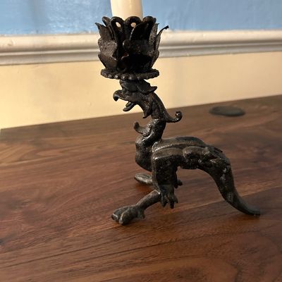 Sale Photo Thumbnail #95: Vintage black cast iron candlestick holder featuring a mythical dragon or wyvern motif with a crown-form candle bobeche.