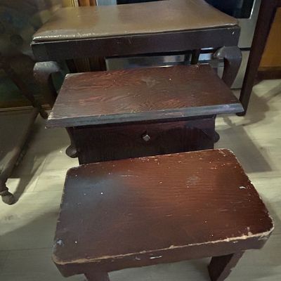Sale Photo Thumbnail #111: Trio of vintage wooden footstools and small benches, including a vinyl-topped bench with cabriole legs and two dark-finished wooden step stools showing wear.