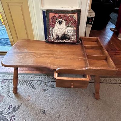 Sale Photo Thumbnail #97: Vintage mid-century wooden cobbler-style bench with a built-in organizer tray and small drawer, paired with a tapestry pillow featuring a fluffy cat.