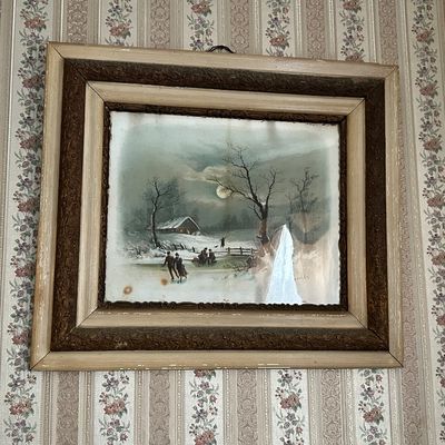 Sale Photo Thumbnail #115: Framed antique winter landscape print depicting ice skaters under a full moon, set in a heavy carved wood and gesso frame with visible wear and discoloration.