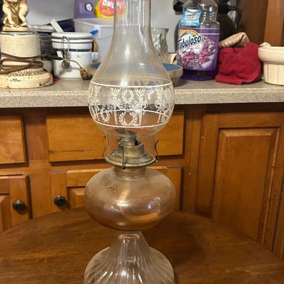Sale Photo Thumbnail #48: Vintage glass oil lamp featuring an etched floral glass chimney and ribbed pedaled base.