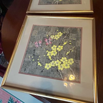 Sale Photo Thumbnail #78: Pair of framed Asian-style botanical prints with yellow blossoms and pink butterflies set against a textured background in thin gold-tone frames.